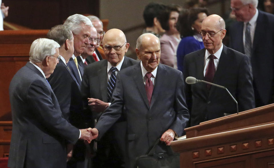 The Church of Jesus Christ of Latter-day Saints President Russell M. Nelson, center, greets the conference of The Church of Jesus Christ of Latter-day Saints Saturday, April 6, 2019, in Salt Lake City. Church members are preparing for more changes as they gather in Utah for a twice-yearly conference to hear from the faith's top leaders. (AP Photo/Rick Bowmer)