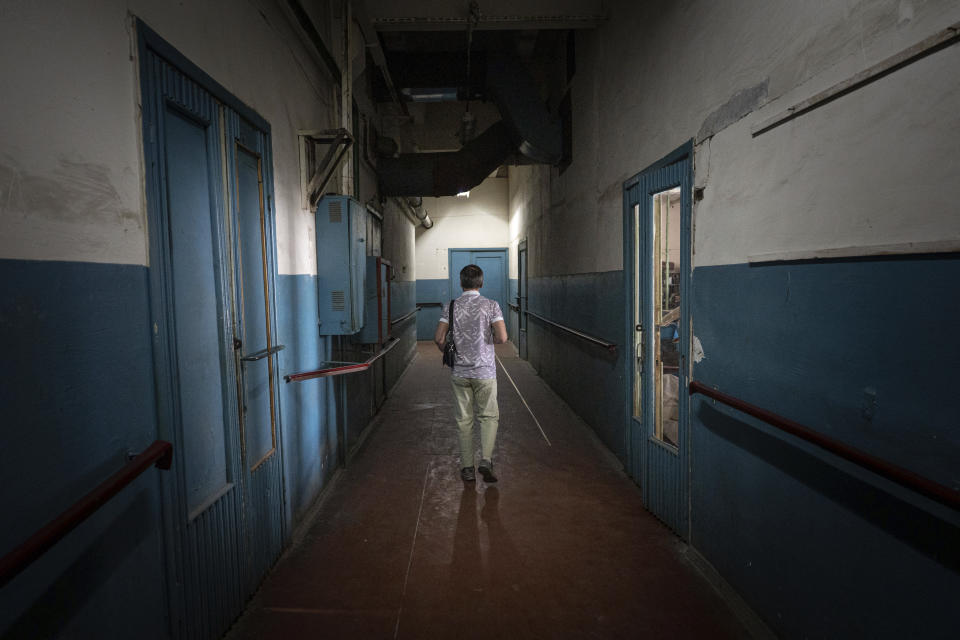 Volodymyr Holubenko, 62, who is blind, walks inside a manufacturing plant where visually impaired people used to work until it was shuttered after a Russian air assault in Kyiv, Ukraine, on May 30, 2023. "I heard everything. Our doors at home were shuddering," said Holubenko, who has been working at the company for 47 years. Losing the place of work is just one of a multitude of challenges that people with visual impairments face across Ukraine since Russia launched a full-scale invasion in February 2022. (AP Photo/Roman Hrytsyna)