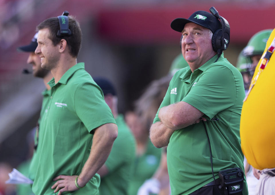North Dakota head coach Bubba Schweigert, right, looks up at the scoreboard during the second half as time runs out in his team's loss to Nebraska in an NCAA college football game Saturday, Sept. 3, 2022, in Lincoln, Neb. (AP Photo/Rebecca S. Gratz)