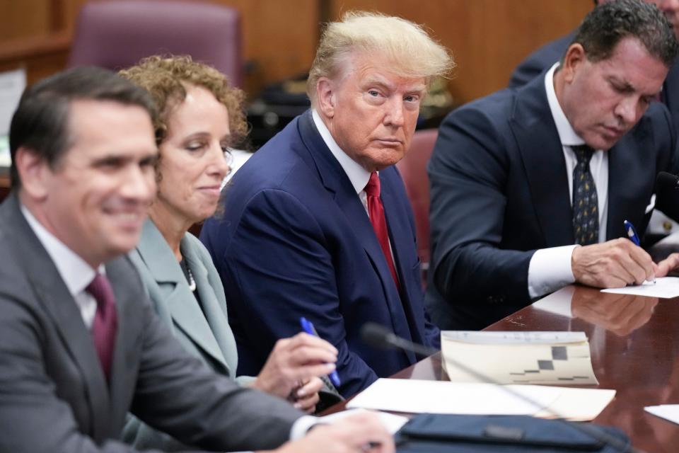 Flanked by his attorneys, former President Donald Trump attends his arraignment April 4, 2023, in New York City after being indicted by a grand jury that heard evidence about a hush money payment to adult film star Stormy Daniels.