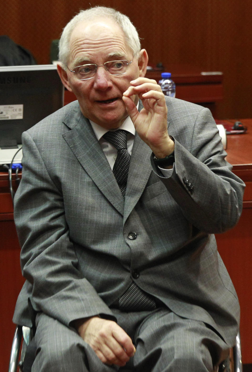 German Finance Minister Wolfgang Schaeuble gestures as he talks with colleagues, prior to the start of the EU finance ministers meeting at the European Council building in Brussels, Tuesday, Feb. 18, 2014. (AP Photo/Yves Logghe)