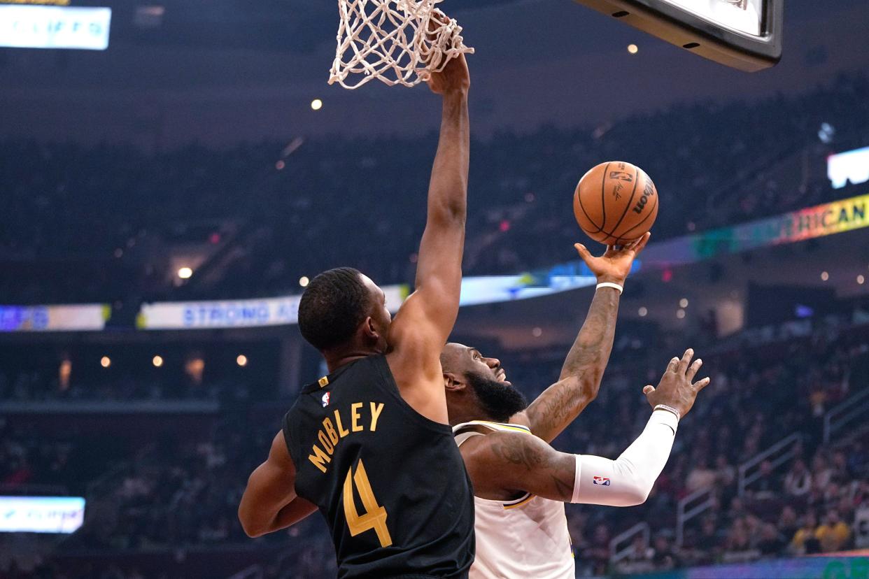 Lakers forward LeBron James, right, shoots in front of Cavaliers forward Evan Mobley during the first half, Saturday, Nov. 25, 2023, in Cleveland.