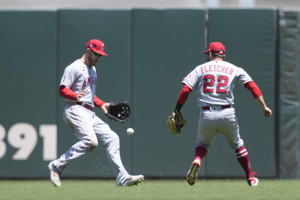Los Angeles Angels center fielder Taylor Ward, left, cannot make the catch on a popup fly hit by San Francisco Giants' Steven Duggar as shortstop baseman David Fletcher (22) looks on during the third inning of a baseball game Monday, May 31, 2021, in San Francisco. (AP Photo/Tony Avelar)