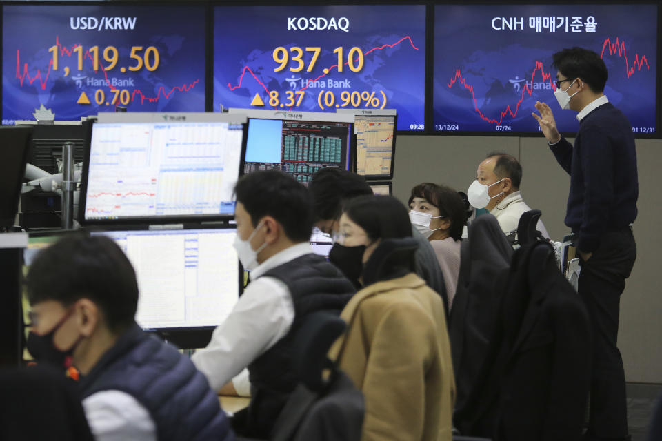 Currency traders work at the foreign exchange dealing room of the KEB Hana Bank headquarters in Seoul, South Korea, Monday, Feb. 1, 2021. Asian stock markets gained Monday after coronavirus vaccine maker AstraZeneca agreed to increase supplies to Europe amid rising worries about the disease.(AP Photo/Ahn Young-joon)