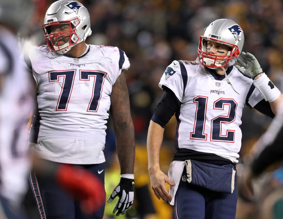 Could Trent Brown (77) and quarterback Tom Brady (12) be reunited on the Las Vegas Raiders? (Photo by Jim Davis/The Boston Globe via Getty Images)