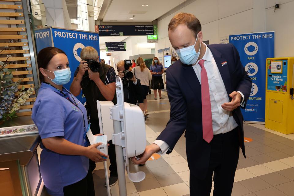 Matt Hancock applies hand sanitiser during a tour of Chelsea and Westminster hospital in London (REUTERS)