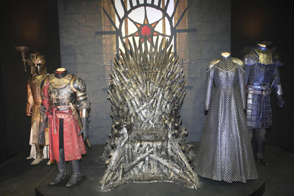 FILE - The Iron Throne and costumes on display during the launch of The Game of Thrones Touring Exhibition at the Titanic Exhibition centre in Belfast, Northern Ireland, Wednesday, April 10, 2019. (AP Photo, File)