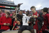 Cincinnati's Ahmad Gardner (1) takes a selfie as he celebrates with fans after Cincinnati defeated Notre Dame, 24-13, in an NCAA college football game, Saturday, Oct. 2, 2021, in South Bend, Ind. (AP Photo/Darron Cummings)