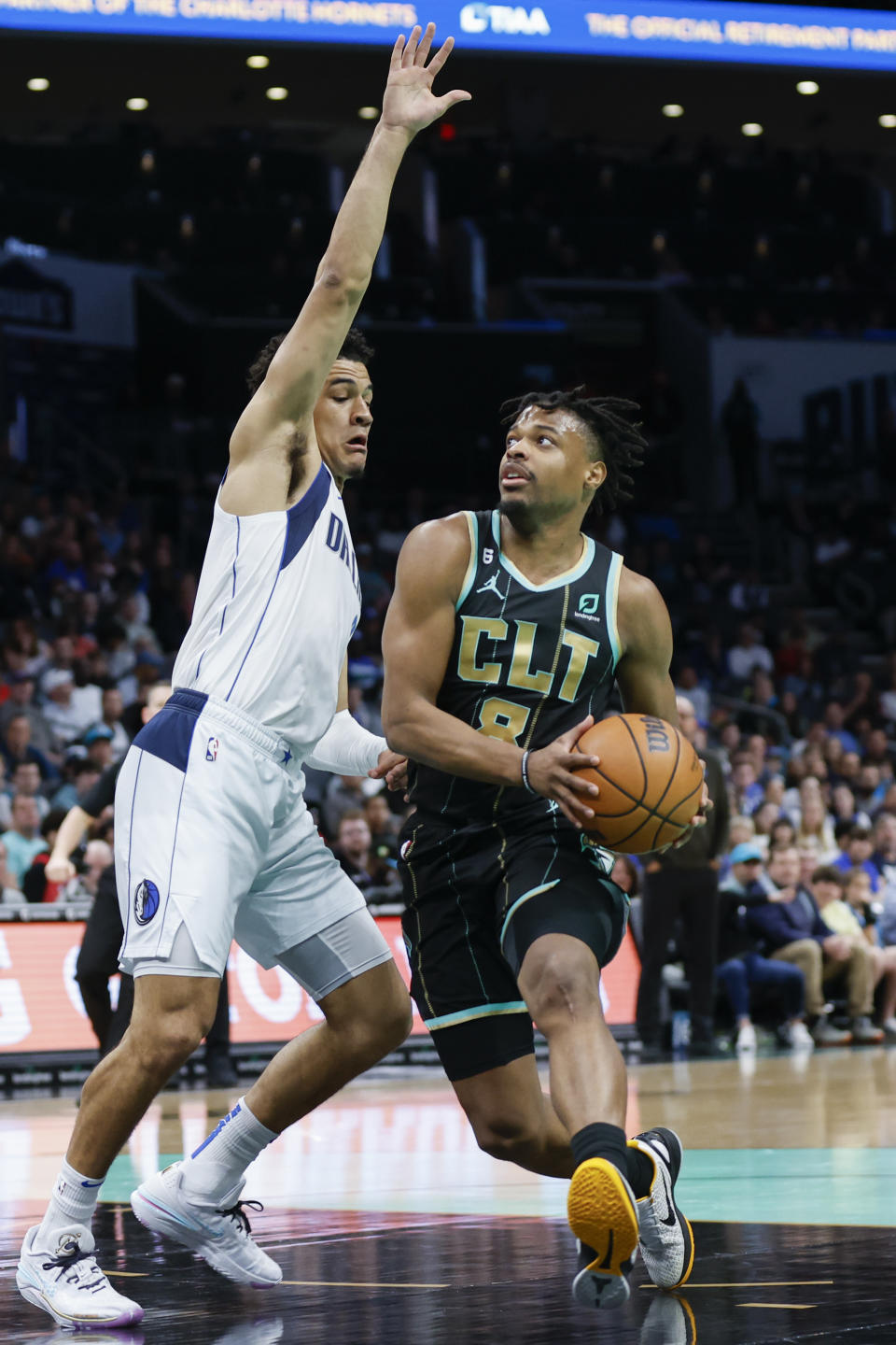 Charlotte Hornets guard Dennis Smith Jr., right, drives to the basket as Dallas Mavericks guard Josh Green defends during the first half of an NBA basketball game in Charlotte, N.C., Sunday, March 26, 2023. (AP Photo/Nell Redmond)