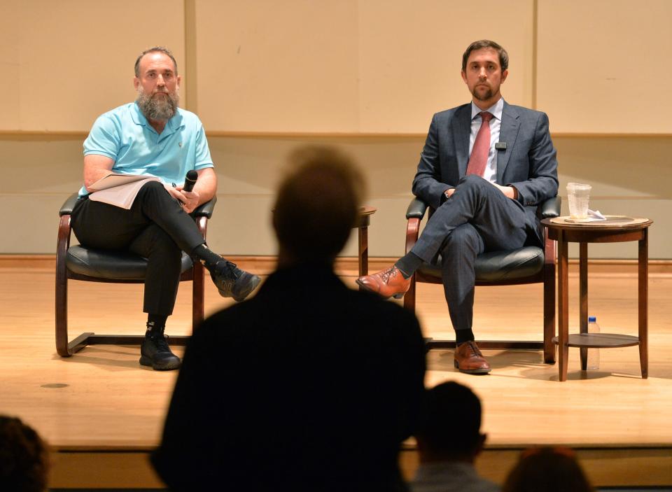 Recently appointed trustees of New College of Florida, Jason u0022Eddieu0022 Speir, left, and Christopher Rufo, listen to a question from a faculty member on Jan. 25, 2023.