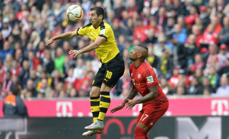 Dortmund's midfielder Henrikh Mkhitaryan (L) and Bayern Munich's defender Jerome Boateng jump for the ball during a German first division Bundesliga football match in Munich, southern Germany, on October 4, 2015