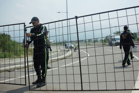 A security officer stands guard on the road to the Tienditas cross-border bridge between Colombia and Venezuela, in Cucuta, Colombia February 6, 2019. REUTERS/Carlos Eduardo Ramirez