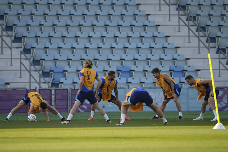 England players stretch during a training session at Al Wakrah Sports Complex on the eve of the Round of 16 World Cup soccer match between England and Senegal, in Al Wakarah, Qatar, Saturday, Dec. 3, 2022. (AP Photo/Abbie Parr)