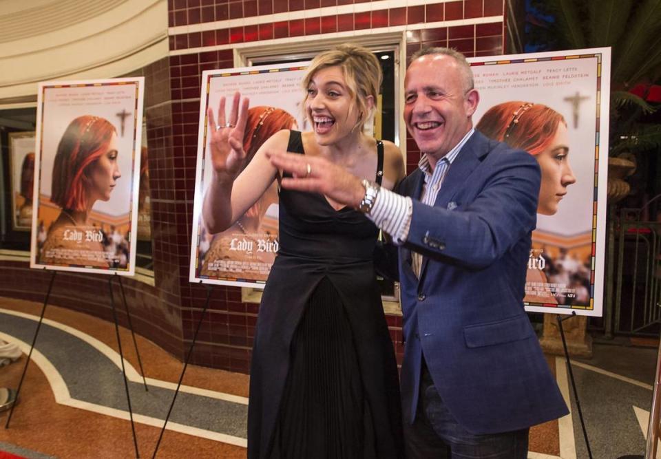 Sacramento film actor and director Greta Gerwig waves to fans with Mayor Darrell Steinberg as she walks down the red carpet for the premiere of her film “Lady Bird” at the Tower Theatre in Sacramento on Oct. 29, 2017.