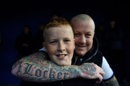 Whitby Town fans, Dylan Locker aged 10 and his Dad, Danny Locker pose for a picture during the soccer match between Whitby Town F.C. and Basford United at the Turnbull Ground in Whitby, Britain March 2, 2019. REUTERS/Clodagh Kilcoyne