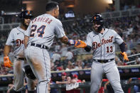 Detroit Tigers' Eric Haase (13) is congratulated by Miguel Cabrera after hitting a grand slam off Minnesota Twins pitcher Hansel Robles during the ninth inning of a baseball game Tuesday, July 27, 2021, in Minneapolis. The Tigers won 6-5 in 11 innings. (AP Photo/Jim Mone)