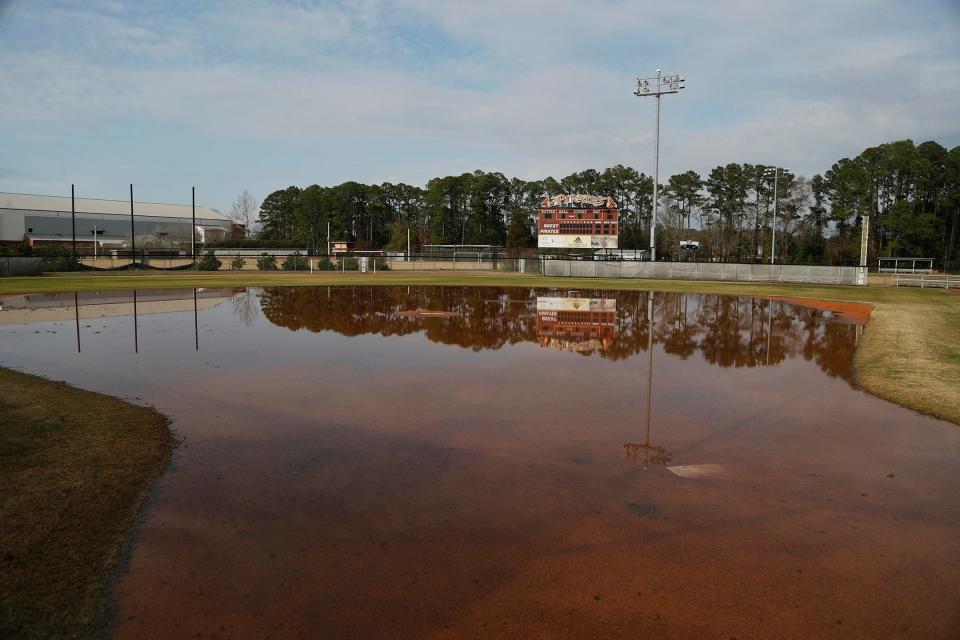 Water from recent rains stands on the infield at a softball field on the Georgia Southern University Armstrong Campus.