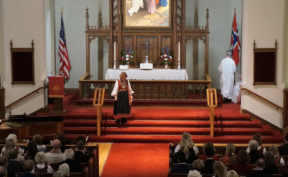 Queen Sonja of Norway walks down the steps after speaking at the podium at Den Norske Lutherske Mindekirke, the Norwegian Lutheran Memorial Church in Minneapolis, Sunday Oct. 16, 2022. (AP Photo/Giovanna Dell'Orto)