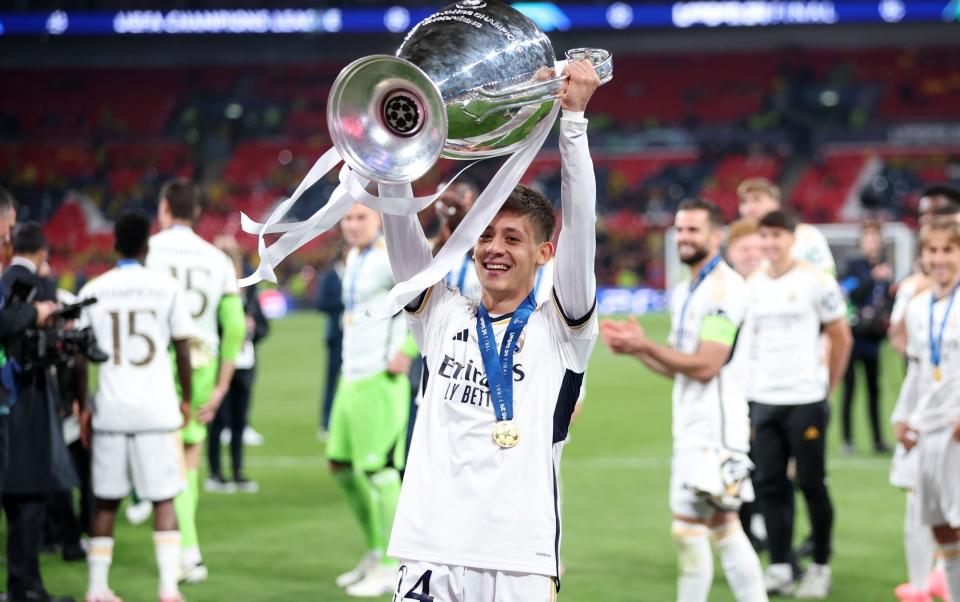 Arda Guler lifts the Champions League trophy