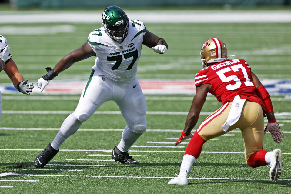 FILE - In this Sunday, Sept. 20, 2020, file photo, New York Jets offensive tackle Mekhi Becton (77) looks to block against the San Francisco 49ers during an NFL football game in East Rutherford, N.J. Becton flings 300-pound defenders to the ground as if they're merely little rag dolls. This is exactly what the Jets envisioned when they drafted the 6-foot-7, 363-pound behemoth out of Louisville. (AP Photo/Adam Hunger, File)