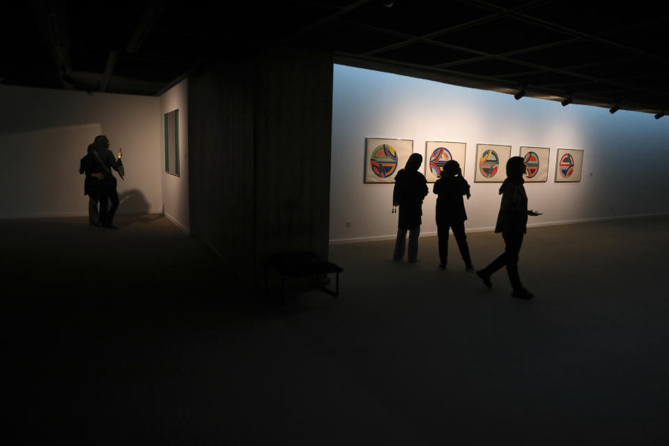 People visit a 19th and 20th-century American and European minimalist and conceptual masterpieces show at the Tehran Museum of Contemporary Art in Tehran, Iran, Tuesday, Aug. 2, 2022. Some of the world’s most prized works of contemporary Western art have been unveiled for the first time in decades — in Tehran. (AP Photo/Vahid Salemi)