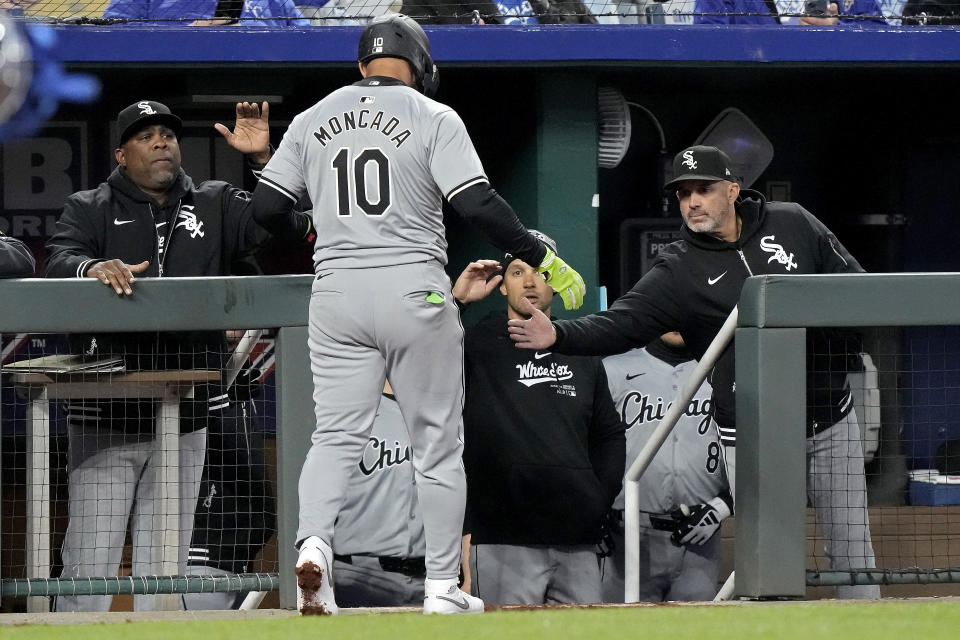 Chicago White Sox's Yoán Moncada celebrates as he walks into the dugout after scoring an a single hit by Andrew Vaughn during the sixth inning of a baseball game against the Kansas City Royals Thursday, April 4, 2024, in Kansas City, Mo. (AP Photo/Charlie Riedel)