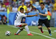 Costa Rica's Cristian Gamboa (L) and Uruguay's Cristian Rodriguez fight for the ball during their 2014 World Cup Group D soccer match at the Castelao stadium in Fortaleza June 14, 2014. (Dominic Ebenbichler/Reuters)