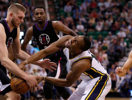 Apr 8, 2016; Salt Lake City, UT, USA; Los Angeles Clippers center Cole Aldrich (45) battle for the ball with Utah Jazz guard Alec Burks (10) in overtime at Vivint Smart Home Arena. The Los Angeles Clippers defeated the Utah Jazz 102-99 in overtime. Mandatory Credit: Jeff Swinger-USA TODAY Sports