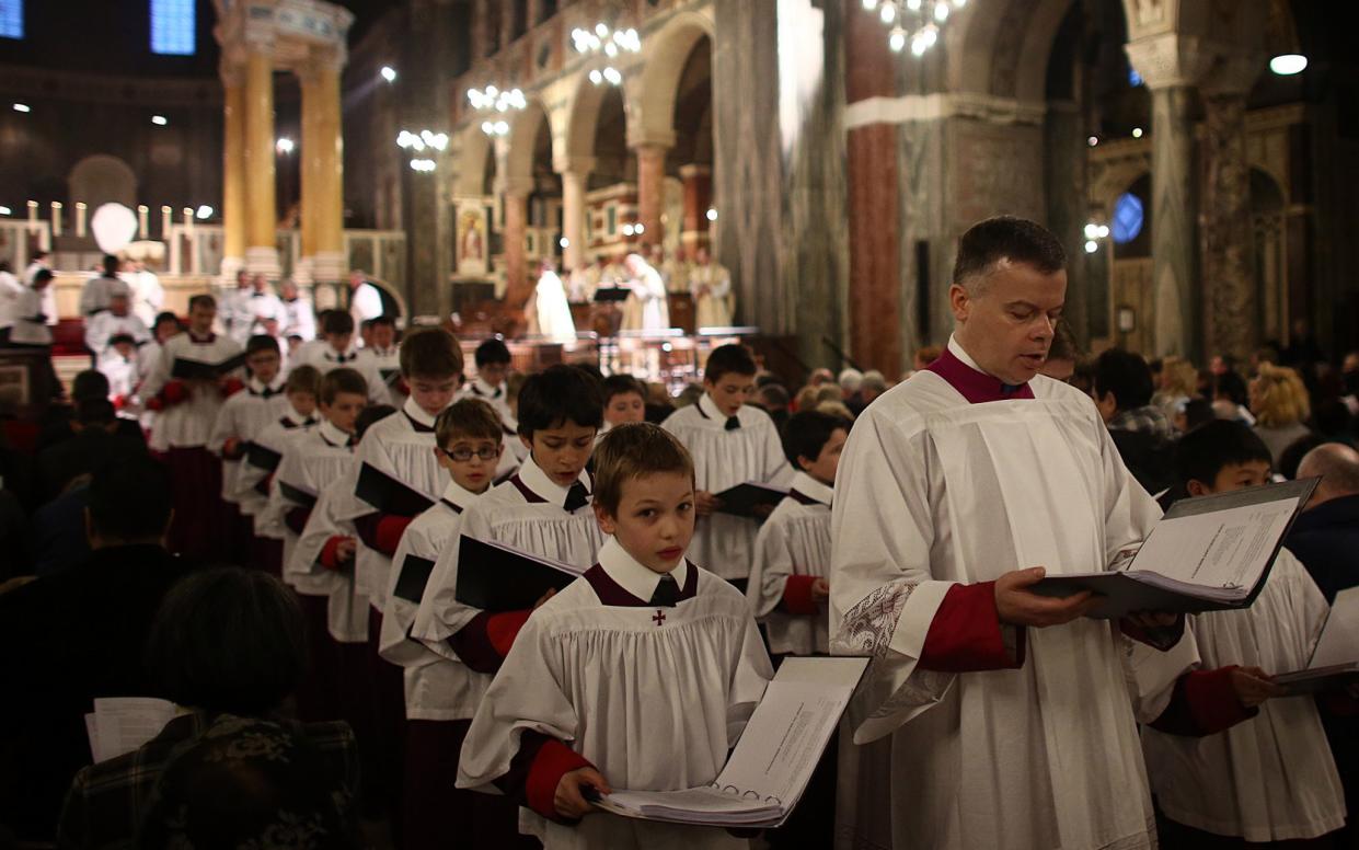 Members of the clergy and choir children form a ceremonial procession following a Maundy service at Westminster Cathedral in April 2015  - Carl Court/Getty Images