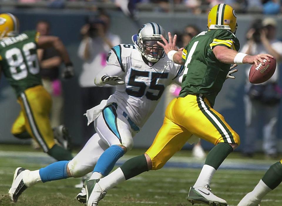 Panthers linebacker Dan Morgan (55) on the full sprint as he tries to chase down Green Bay Packers quarterback Brett Favre in 2001. In 2024, Morgan would become the Panthers’ general manager.