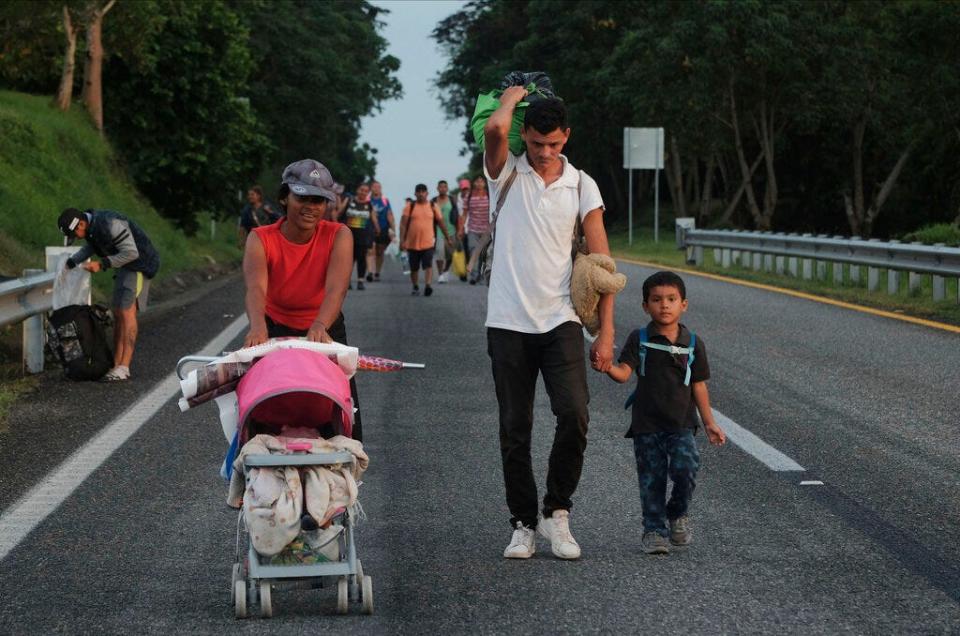 Migrants leave Ulapa, Chiapas state, late Saturday, Oct. 30, 2021. The migrant caravan heading north in southern Mexico has so far been allowed to walk unimpeded, a change from the Mexican government's reaction to other attempted mass migrations. (AP Photo/Isabel Mateos)