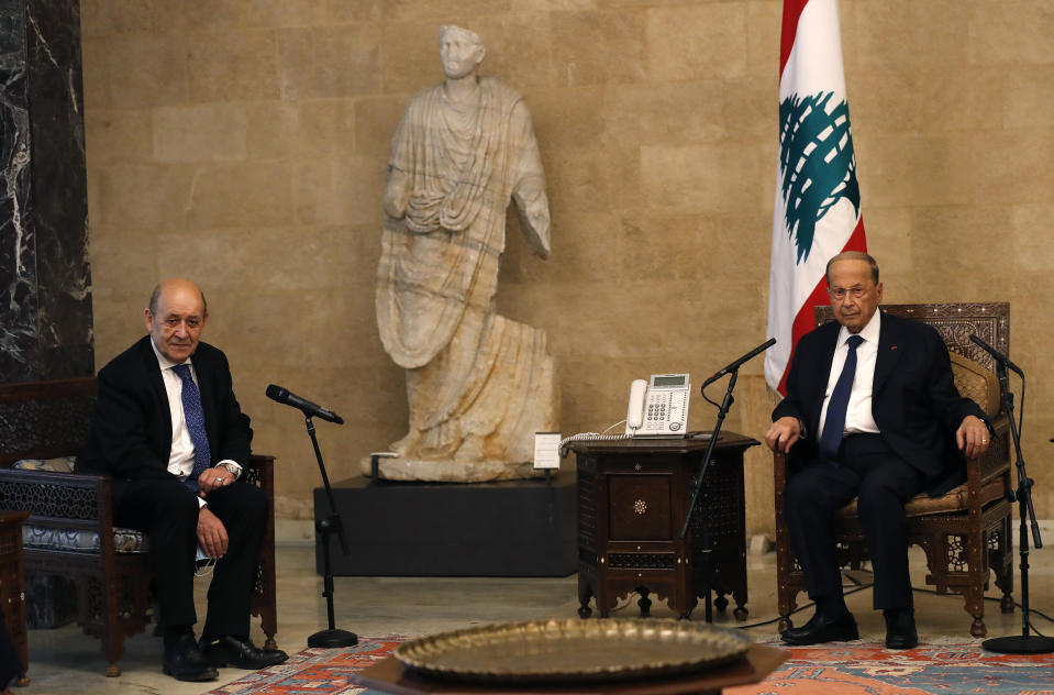 French Foreign Minister Jean-Yves Le Drian, left, meets with Lebanese President Michel Aoun at the Presidential Palace in Baabda, east of Beirut, Lebanon, Thursday, May 6, 2021. Le Drian is in Beirut for two days visit to meet with Lebanese officials. (AP Photo/Hussein Malla)