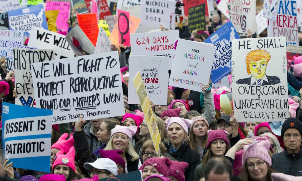 Women wearing pink hats at a protest rally in Washington DC, part of long tradition of dressing up to mock authority figures.