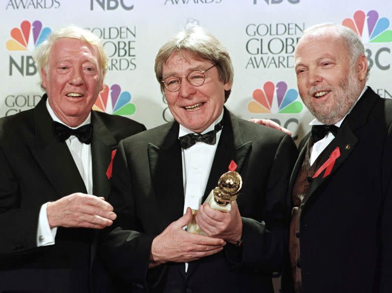 FILE PHOTO: Producer Robert Stigwood (L), director Alan Parker and producer Andrew Vajna (R) celebrate the award