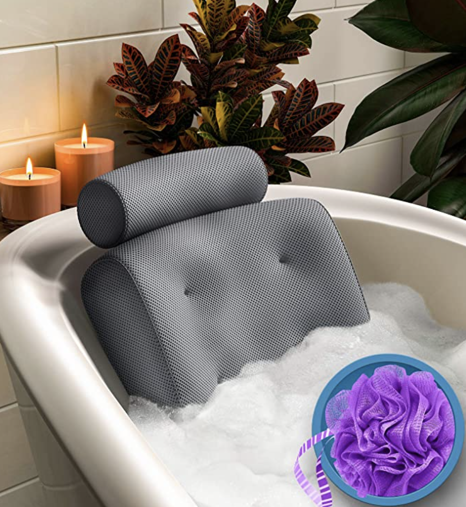 Everlasting Comfort Bath Pillow in bathtub with plants and candles (Photo via Amazon)