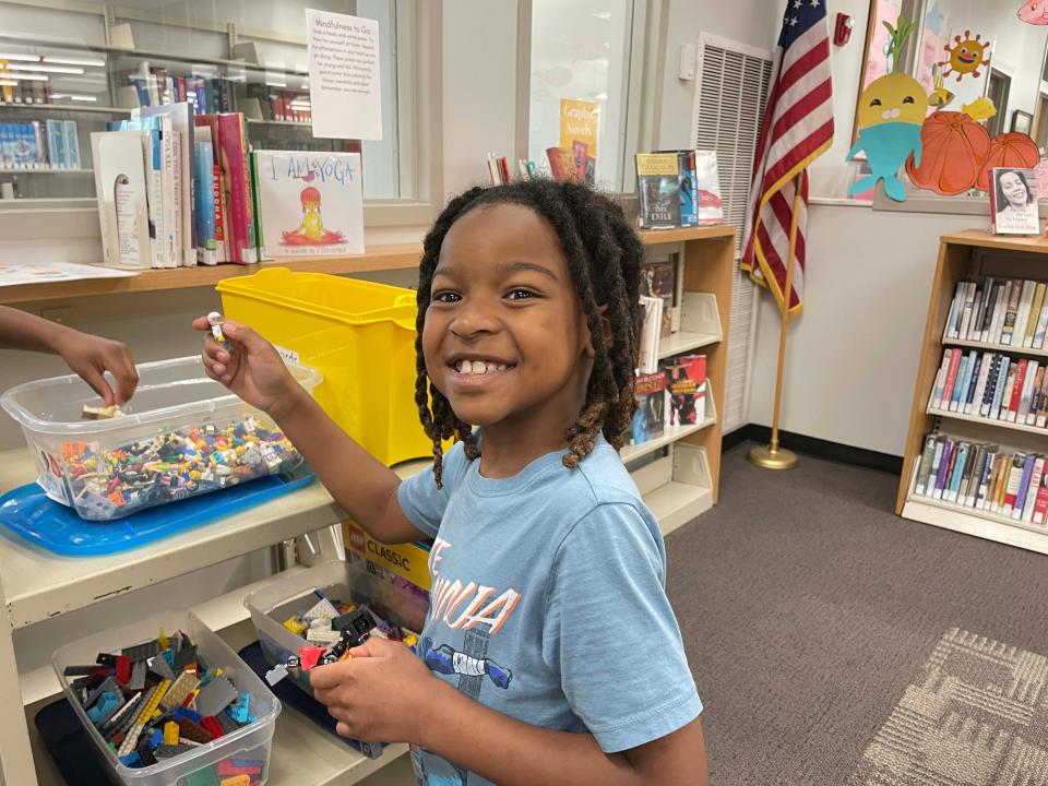 Ayce Johnson, 8, selects his favorite pieces from a bin filled with LEGOs at the monthly LEGO Club at Karns Branch Library Saturday, May 21, 2022.