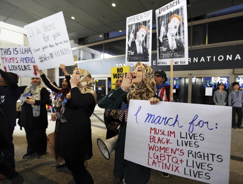 Demonstrators opposed to President Donald Trump's executive orders barring entry to the U.S. by Muslims from seven countries protest at the Tom Bradley International Terminal at Los Angeles International Airport on Saturday, Feb. 4, 2017 (AP Photo/Reed Saxon)