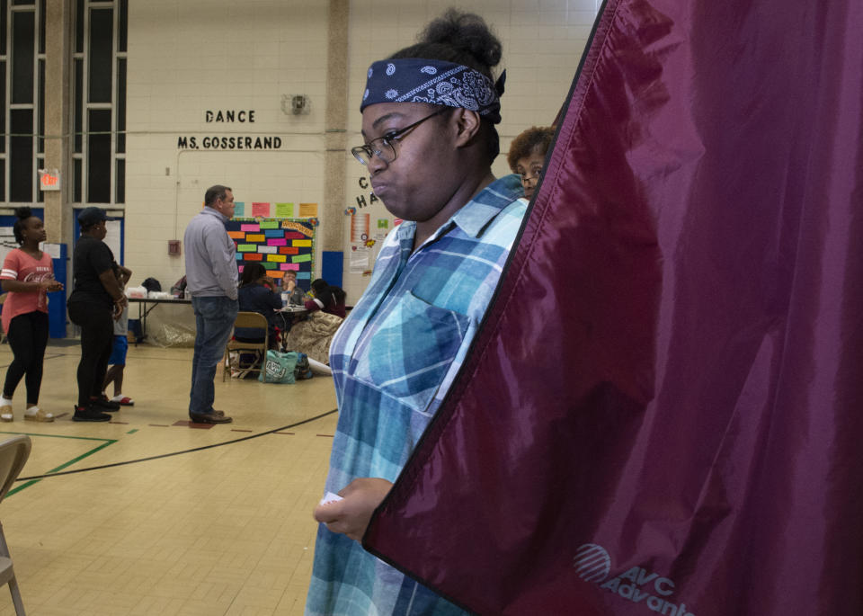 Ashia Ward, 21, exits a polling station after voting for the first time at Sherwood Middle Academic Magnet School on Saturday, Oct. 12, 2019 in Baton Rouge, La. Gov. John Bel Edwards is fighting to hang on to a rare Democratic governorship in Deep South Trump territory, as a national GOP offensive seeks to force him into a runoff. Republicans are trying to hold Edwards under the 50% that he needs Saturday to avoid another election on Nov. 16. (Michael Dunlap/The Advocate via AP)