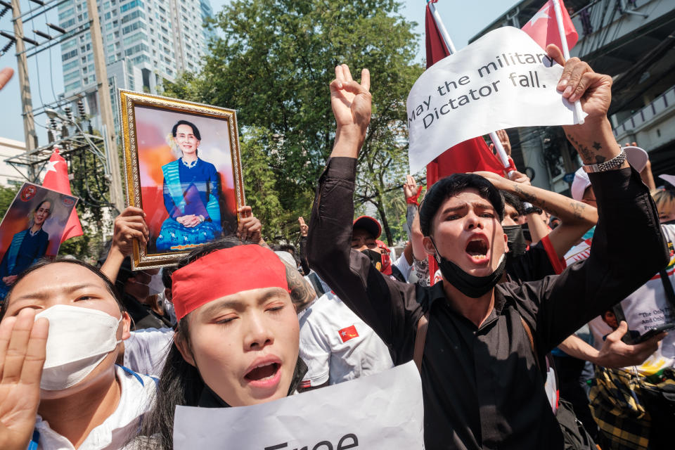 Protesters are shouting slogans while holding pro-democracy signs and pictures of deposed leader Aung San Suu Kyi as the crowd gathers in front of the Myanmar Embassy in Bangkok, Thailand, on February 1, 2023. (Thomas De Cian/NurPhoto via Getty Images)