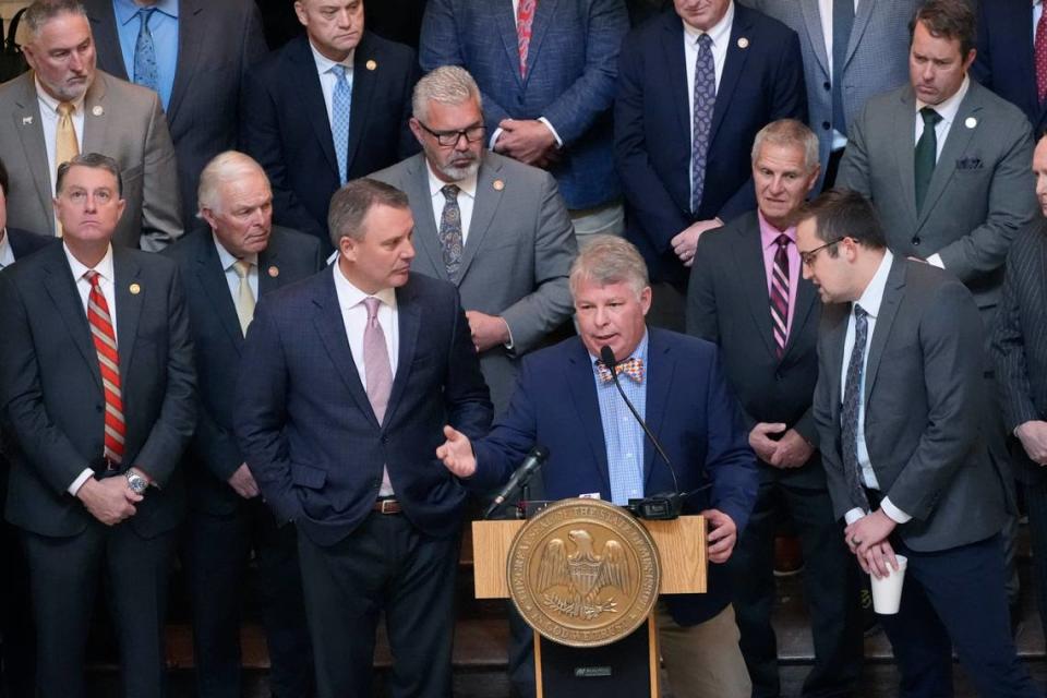 Flanked by members of the Mississippi House of Representatives and Speaker of the House Jason White, R-West, left, Mississippi House Education Committee Chairman Rep. Rob Roberson, R-Starkville, at podium, speaks to reporters about the body’s Wednesday’s passage of a new formula to calculate how much money the state will spend on public schools.