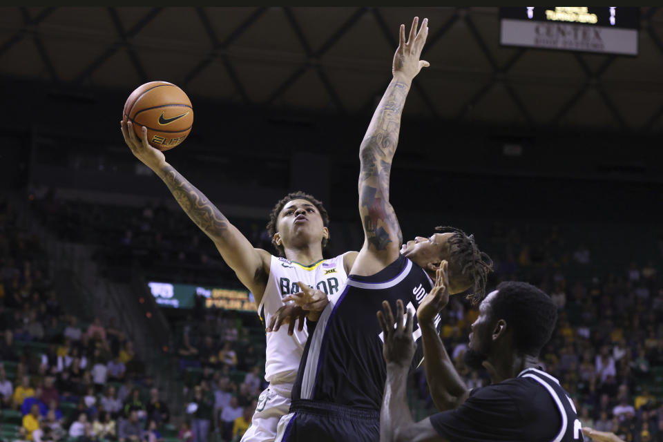 Baylor guard Keyonte George, left, shoots to score over Kansas State forward Keyontae Johnson (11) in the first half of an NCAA college basketball game, Saturday, Jan. 7, 2023, in Waco, Texas. (AP Photo/Rod Aydelotte)