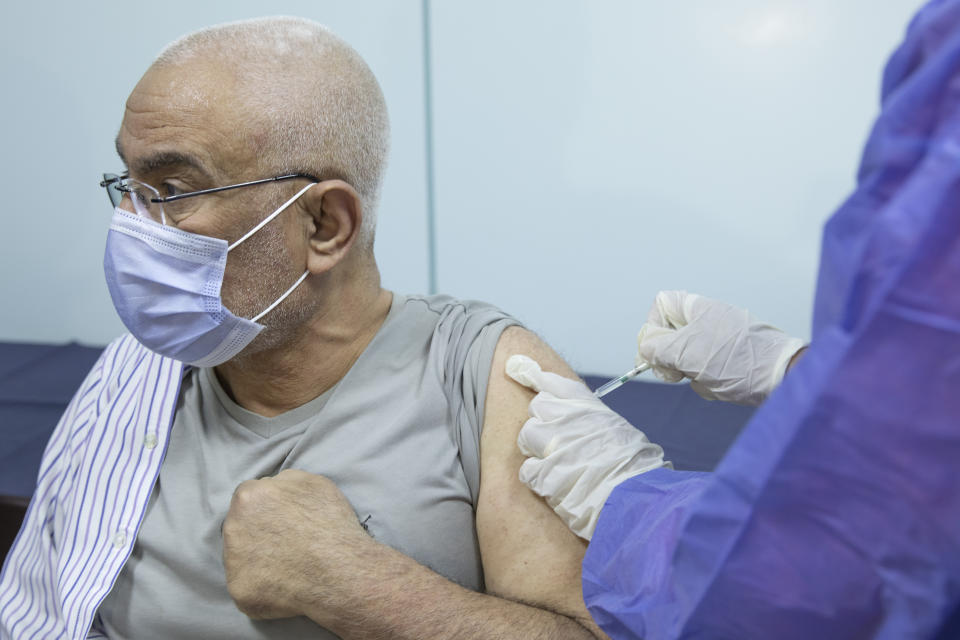 A man receives the AstraZeneca COVID-19 vaccine, at Al-Nozha Hospital in Cairo, Egypt, Thursday, March 4, 2021. (AP Photo/Nariman El-Mofty)