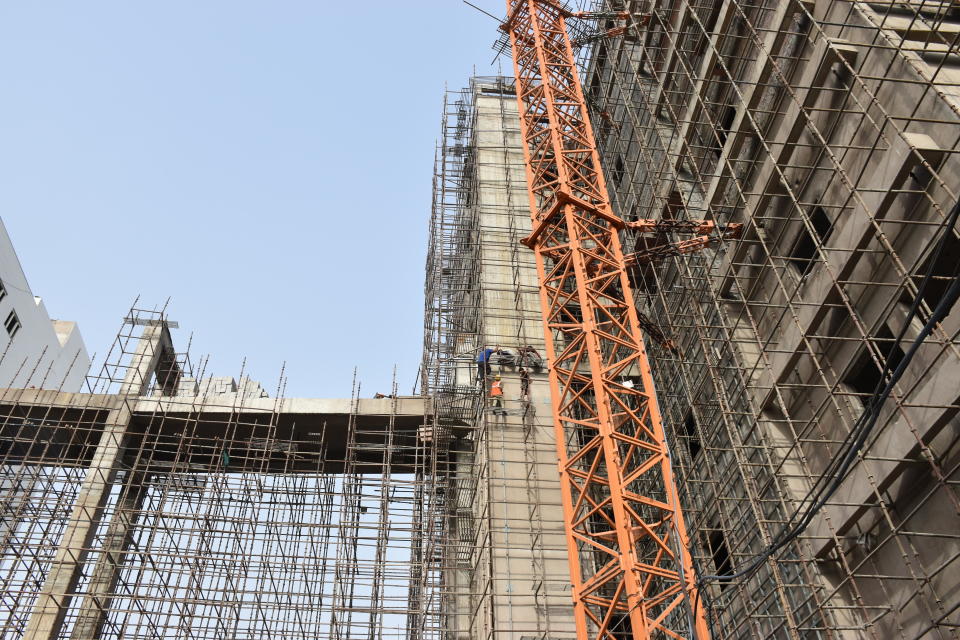 Construction workers toil on scaffolding amid a heat wave in New Delhi, India, May 19, 2022.  / Credit: CBS News