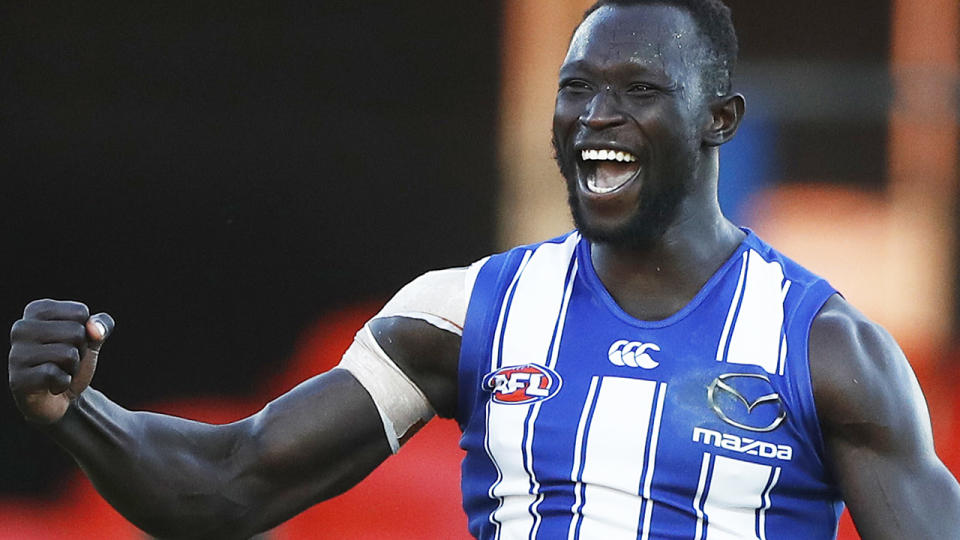 Majak Daw is pictured celebrating after scoring a goal in his AFL comeback for North Melbourne.