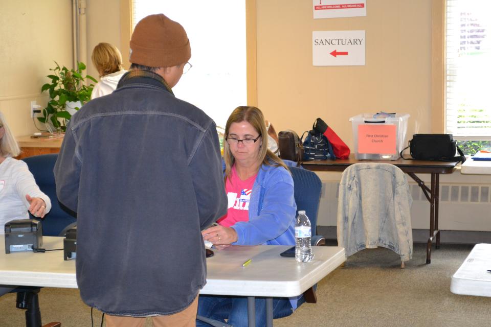 A voter checks in at First Christian Church in Mooresville, one of Morgan County's 14 vote centers, during Tuesday's primary election.