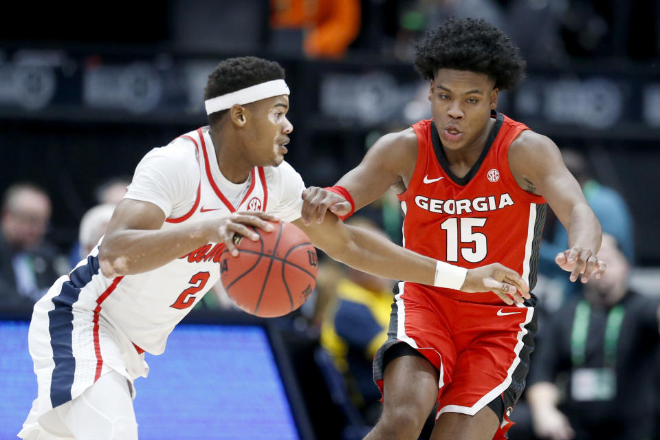 Mississippi guard Devontae Shuler (2) drives against Georgia's Sahvir Wheeler (15) in the first half of an NCAA college basketball game in the Southeastern Conference Tournament Wednesday, March 11, 2020, in Nashville, Tenn. (AP Photo/Mark Humphrey)