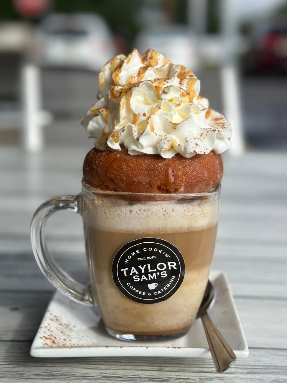 A Pumpkin Donut Latte with homemade pumpkin spice syrup, steamed milk and espresso, topped with a pumpkin donut, whipped cream, caramel and cinnamon, from Taylor Sam's in Brick.