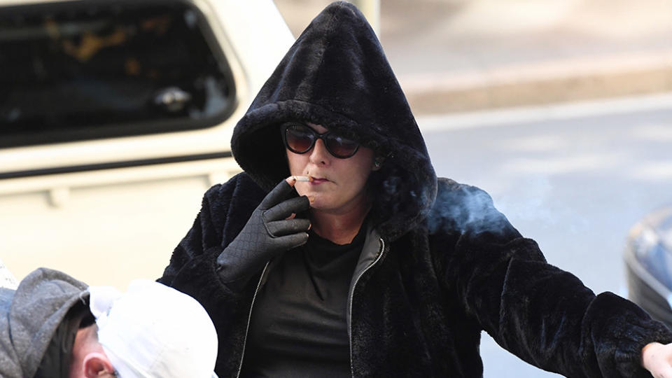 Pictures is Alison Christie Mains having a cigarette, dressed in black with her hood up.