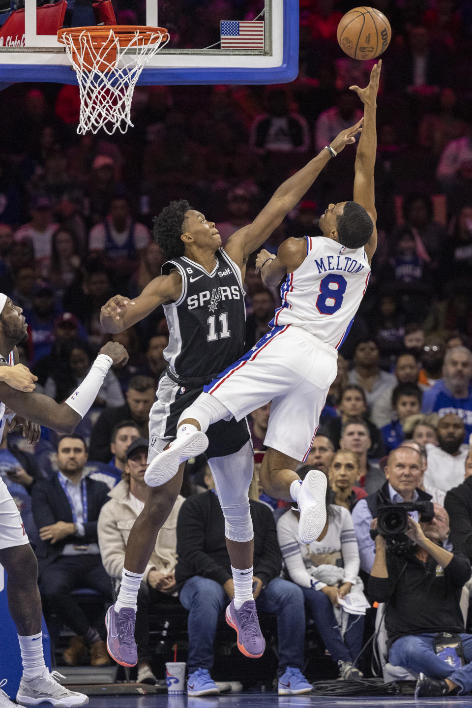 Philadelphia 76ers guard De'Anthony Melton (8) takes a shot over San Antonio Spurs guard Joshua Primo (11) in the first half of an NBA basketball game, Saturday, Oct. 22, 2022, in Philadelphia. (AP Photo/Laurence Kesterson)