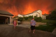 <p>Residents flee their home as flames from the huge California blaze near Santa Clarita. (AFP)</p>